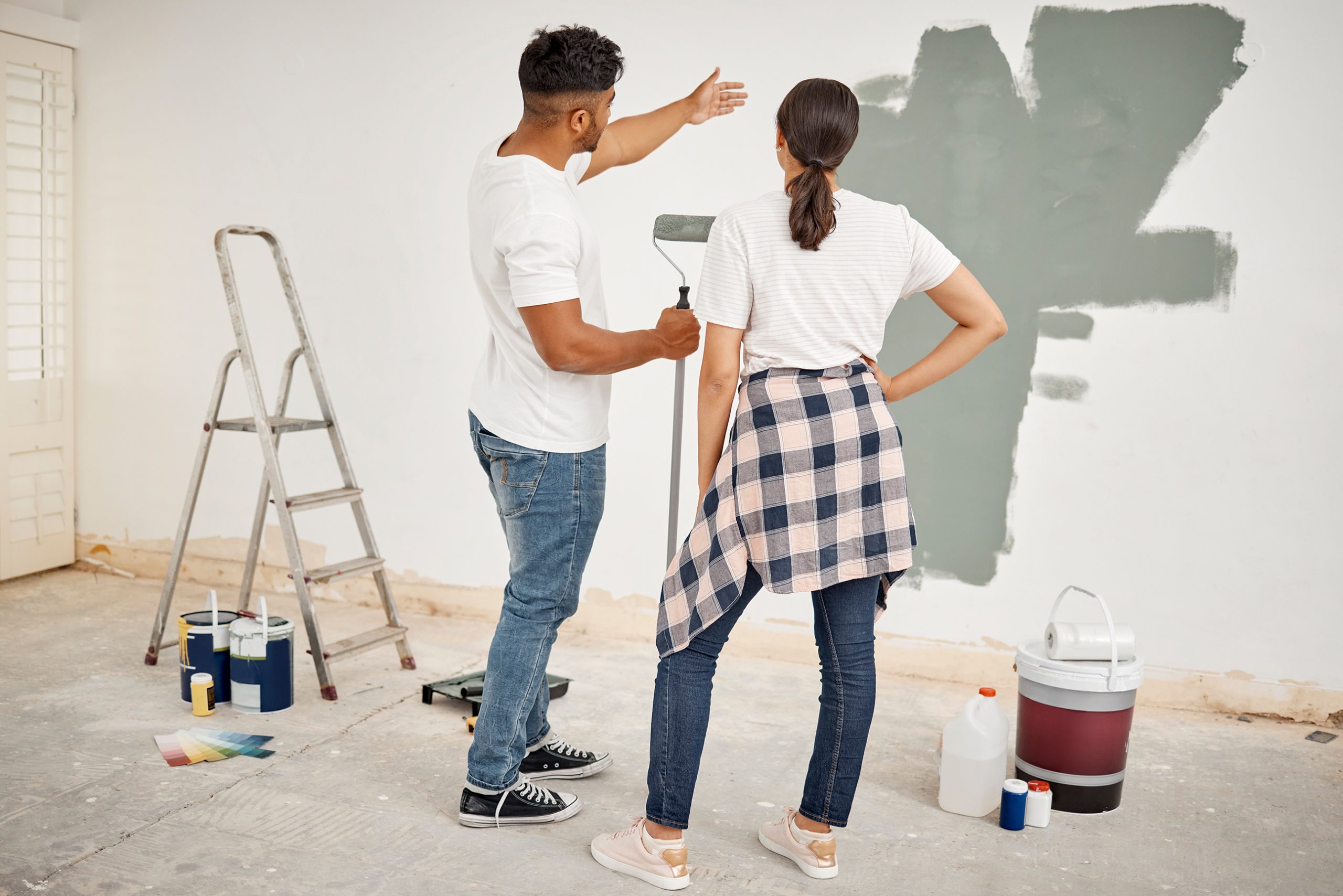 young couple painting a bathroom together